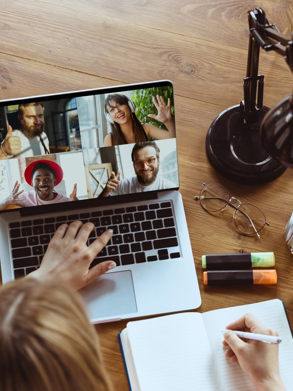 Remote meeting. Woman working from home during coronavirus or COVID-19 quarantine, remote office concept. Young boss, manager in front of laptop during online conference with colleagues and team.