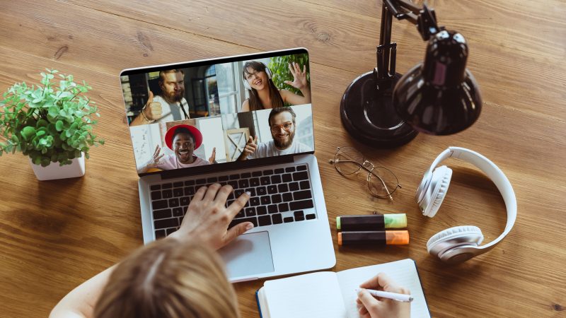 Remote meeting. Woman working from home during coronavirus or COVID-19 quarantine, remote office concept. Young boss, manager in front of laptop during online conference with colleagues and team.